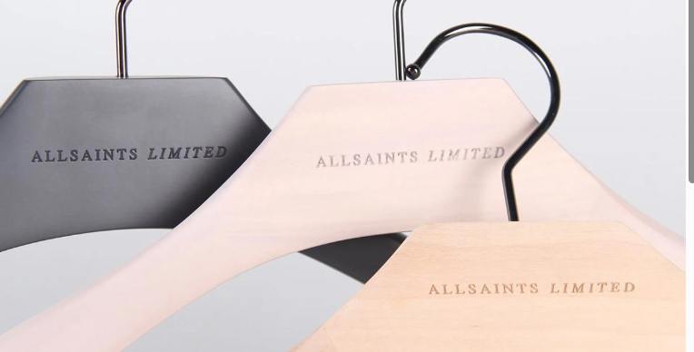 Wooden clothes hangers with “ALLSAINTS LIMITED” logo engraving in black and natural wood finishes.