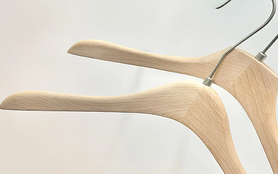 Premium beech wood suit hangers with curved shoulders and stainless steel hooks for coats and blazers.